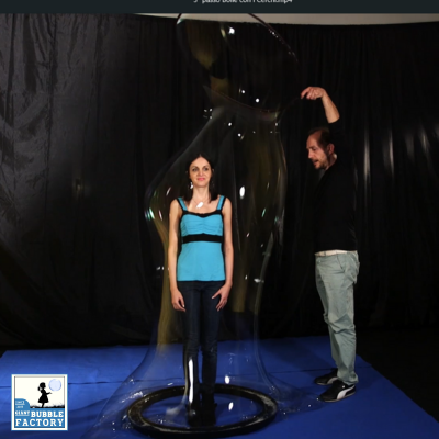 Dimostrazione con persona inglobata in una bolla gigante usando il cerchio inglobabimbi e base con canalina.